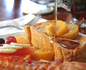 Peach French toast served with fresh bacon strips